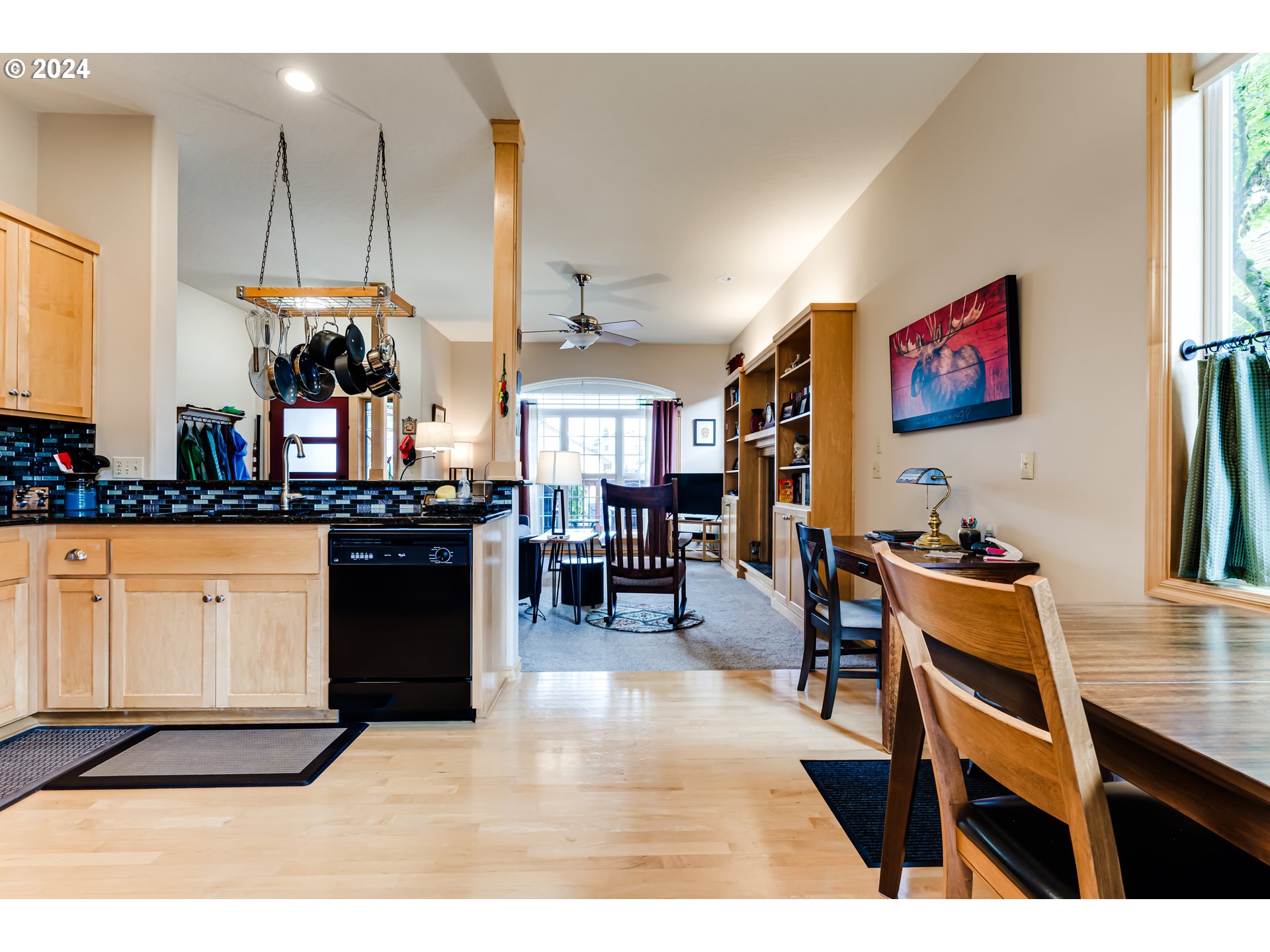 1547 Canal Street Springfield, OR 97477 - Photo 8 of 37 a kitchen with stainless steel appliances kitchen island granite countertop a stove a sink a dining table and chairs