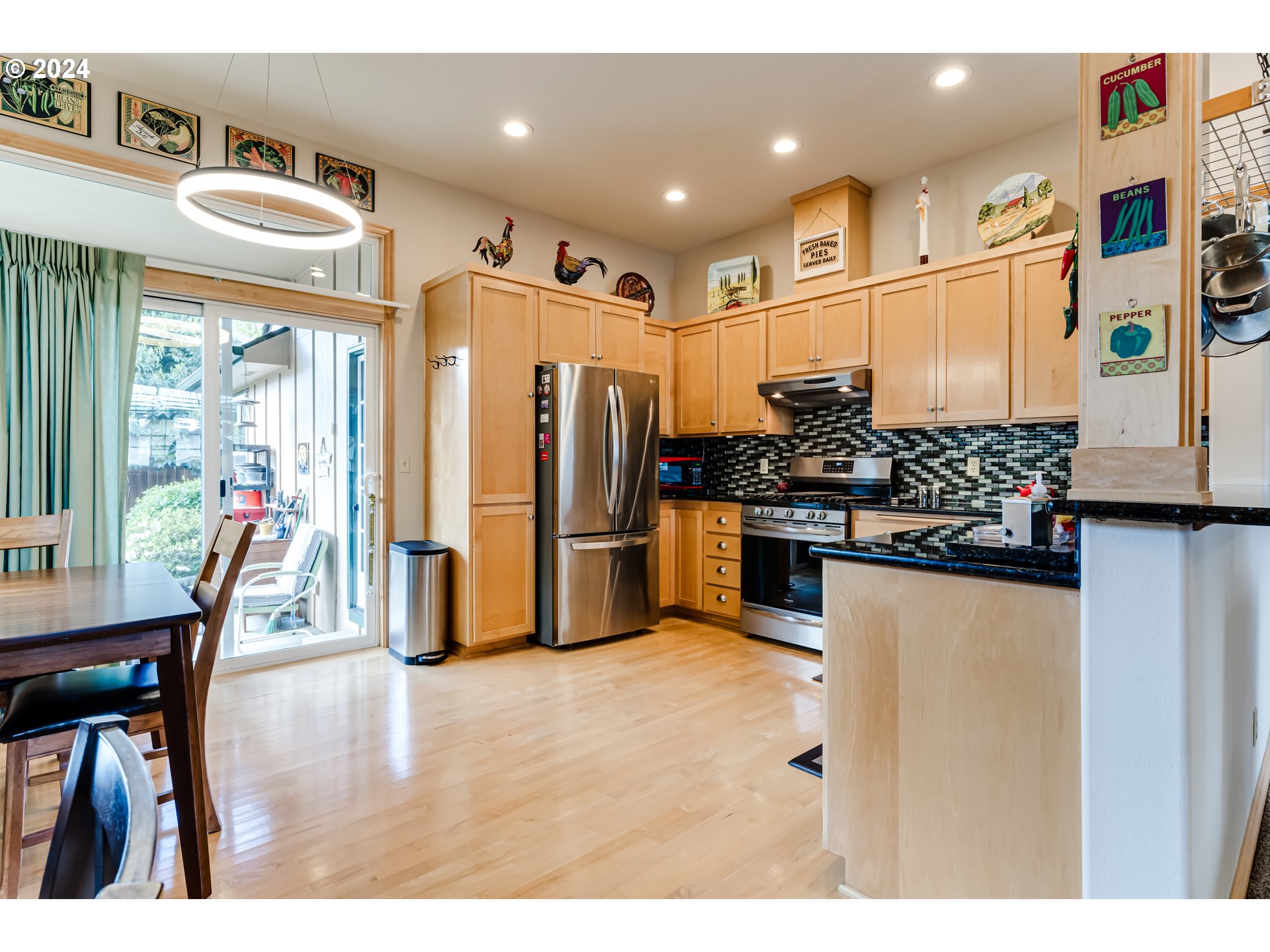 1547 Canal Street Springfield, OR 97477 - Photo 9 of 37 a kitchen with stainless steel appliances kitchen island granite countertop a refrigerator and microwave