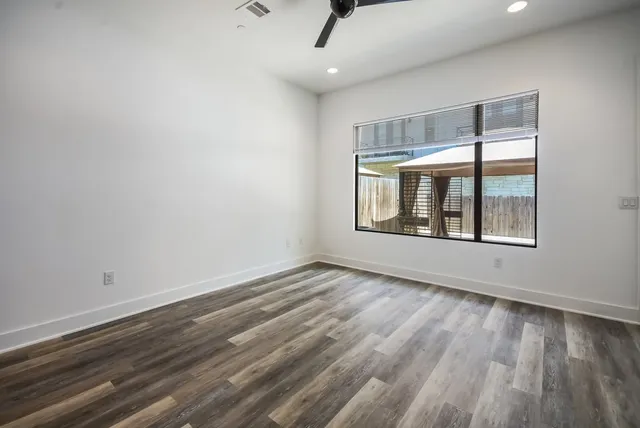 wooden floor in an empty room with a window