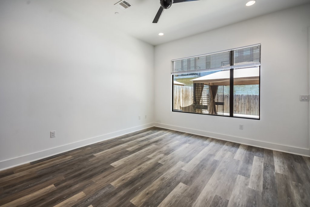 607 West St Johns Avenue, Unit 2 Austin, TX 78752 - Photo 8 of 36 wooden floor in an empty room with a window