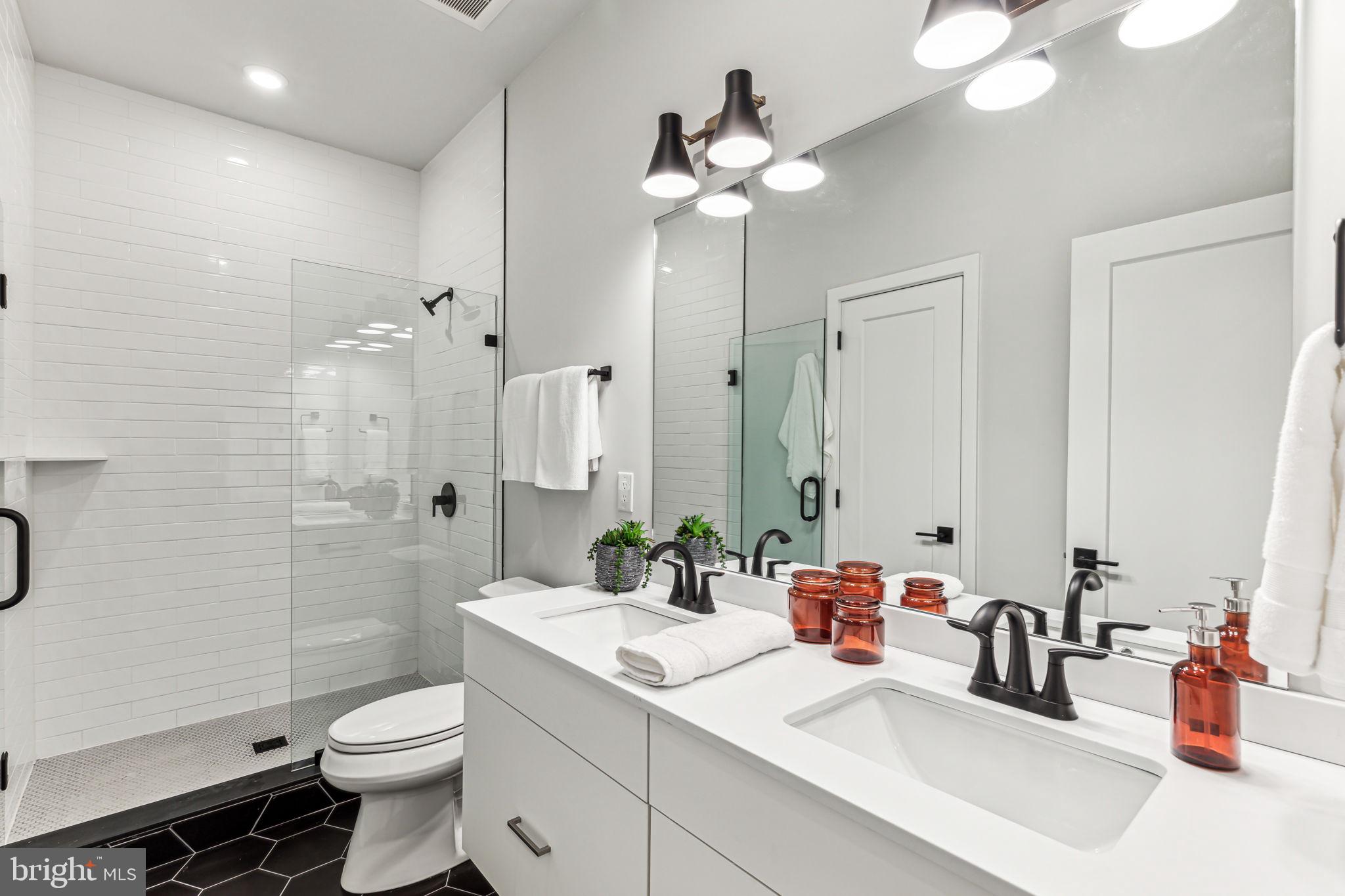 6910 Ridge Avenue, Unit 306 Philadelphia, PA 19128 - Photo 14 of 19 a bathroom with a sink a toilet and shower