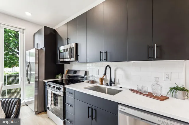 a kitchen with a sink stove and refrigerator