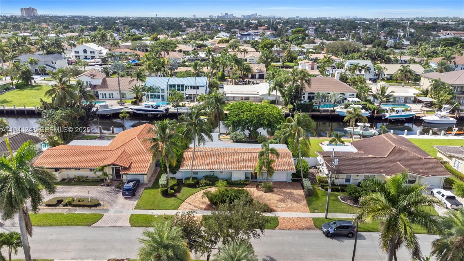 an aerial view of a house with yard swimming pool and ocean view