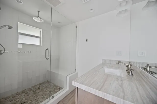a bathroom with a sink and a shower