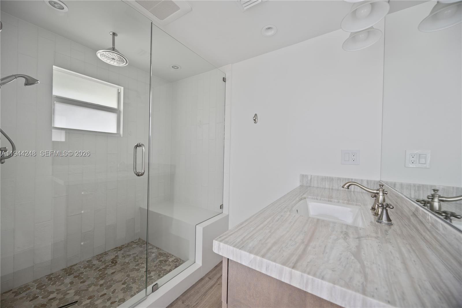 2530 Northeast 48th Street Lighthouse Point, FL 33064 - Photo 11 of 23 a bathroom with a sink and a shower