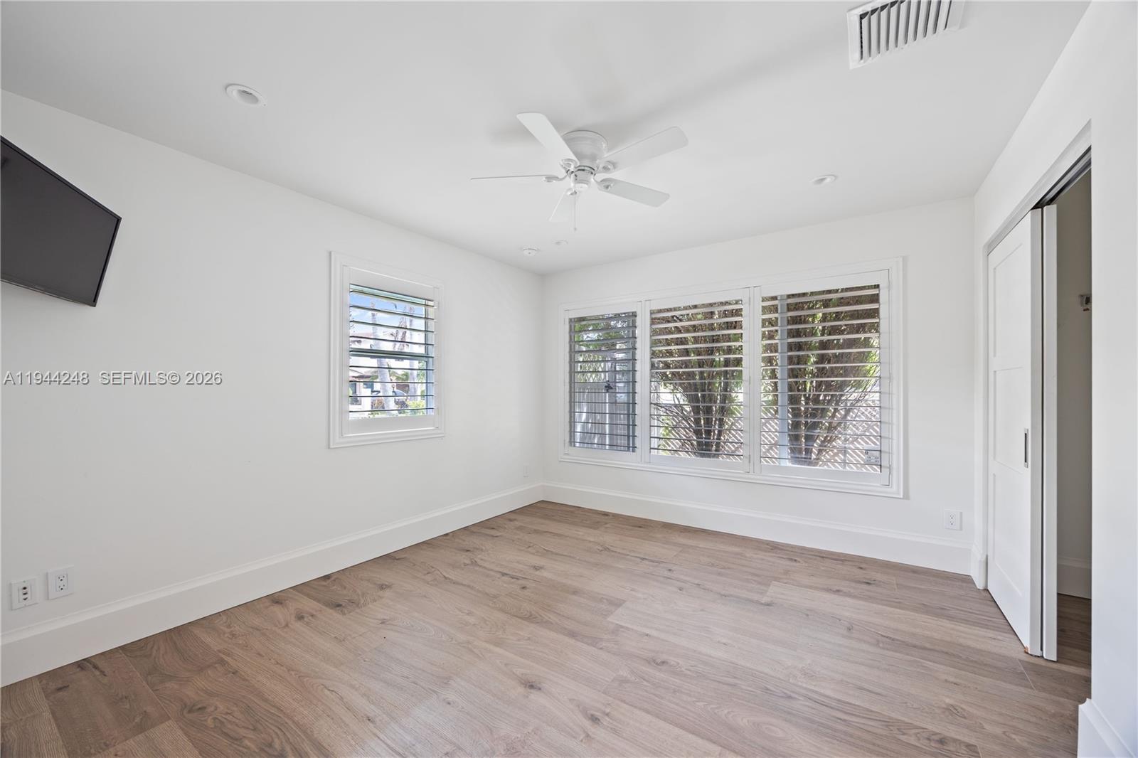 2530 Northeast 48th Street Lighthouse Point, FL 33064 - Photo 13 of 23 a view of an empty room with wooden floor and a window