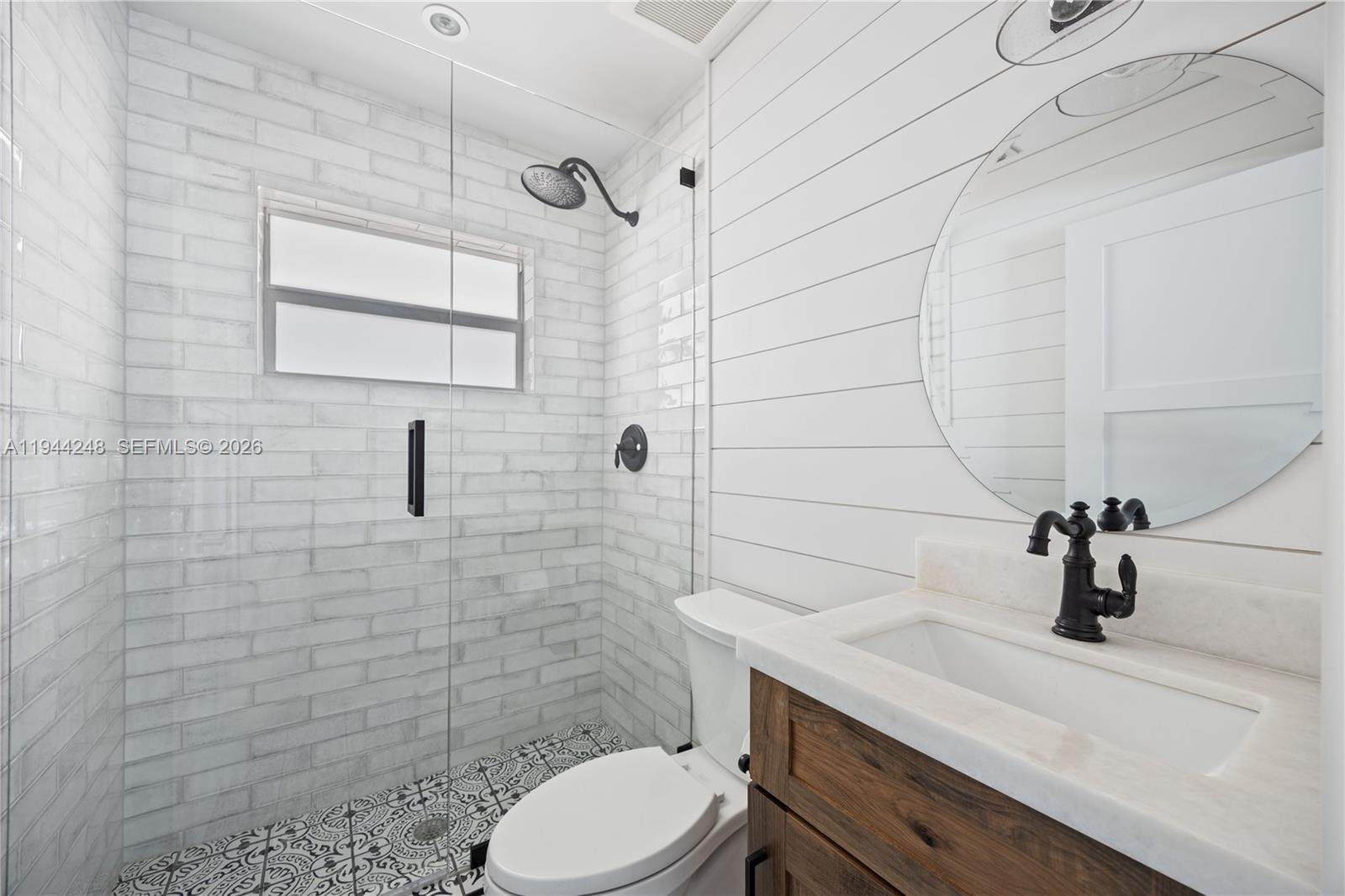 2530 Northeast 48th Street Lighthouse Point, FL 33064 - Photo 15 of 23 a bathroom with a sink a toilet and shower