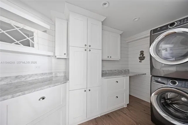 a view of a storage and utility room with wooden floor
