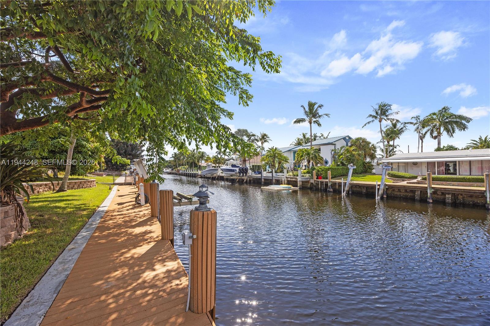 2530 Northeast 48th Street Lighthouse Point, FL 33064 - Photo 20 of 23 a view of a lake with boats and trees in the background