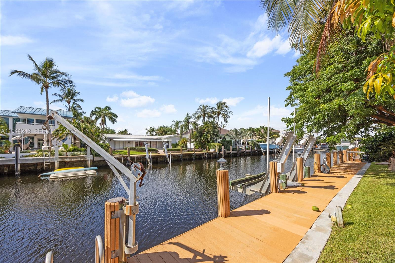 2530 Northeast 48th Street Lighthouse Point, FL 33064 - Photo 2 of 23 a view of a lake with boats and palm trees