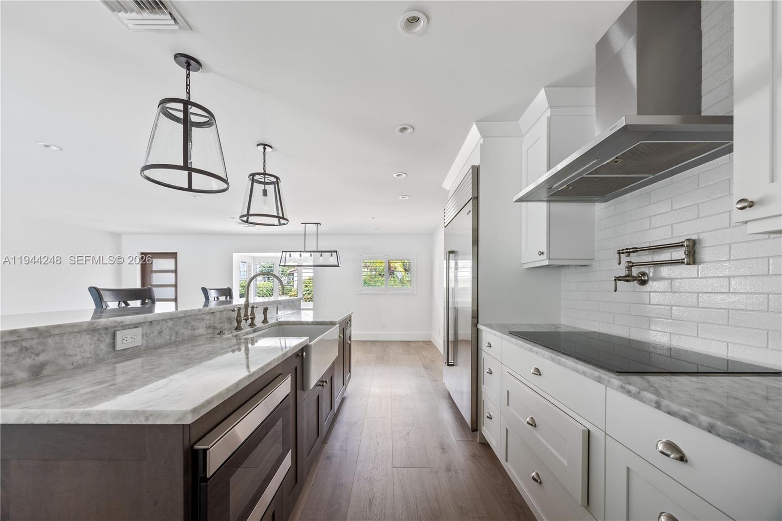 2530 Northeast 48th Street Lighthouse Point, FL 33064 - Photo 7 of 23 a kitchen with granite countertop a sink a counter space appliances and cabinets
