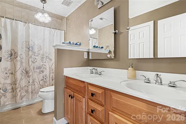 a bathroom with a granite countertop sink a toilet and a mirror