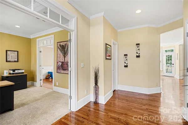 a view of a livingroom with wooden floor and furniture