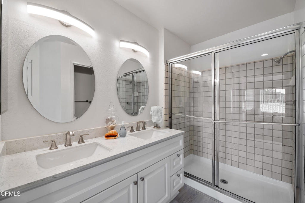 4427 Antigua Way Oxnard, CA 93035 - Photo 18 of 43 a bathroom with a double vanity sink mirror and shower