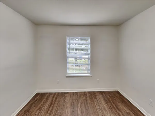 a view of a room with wooden floor