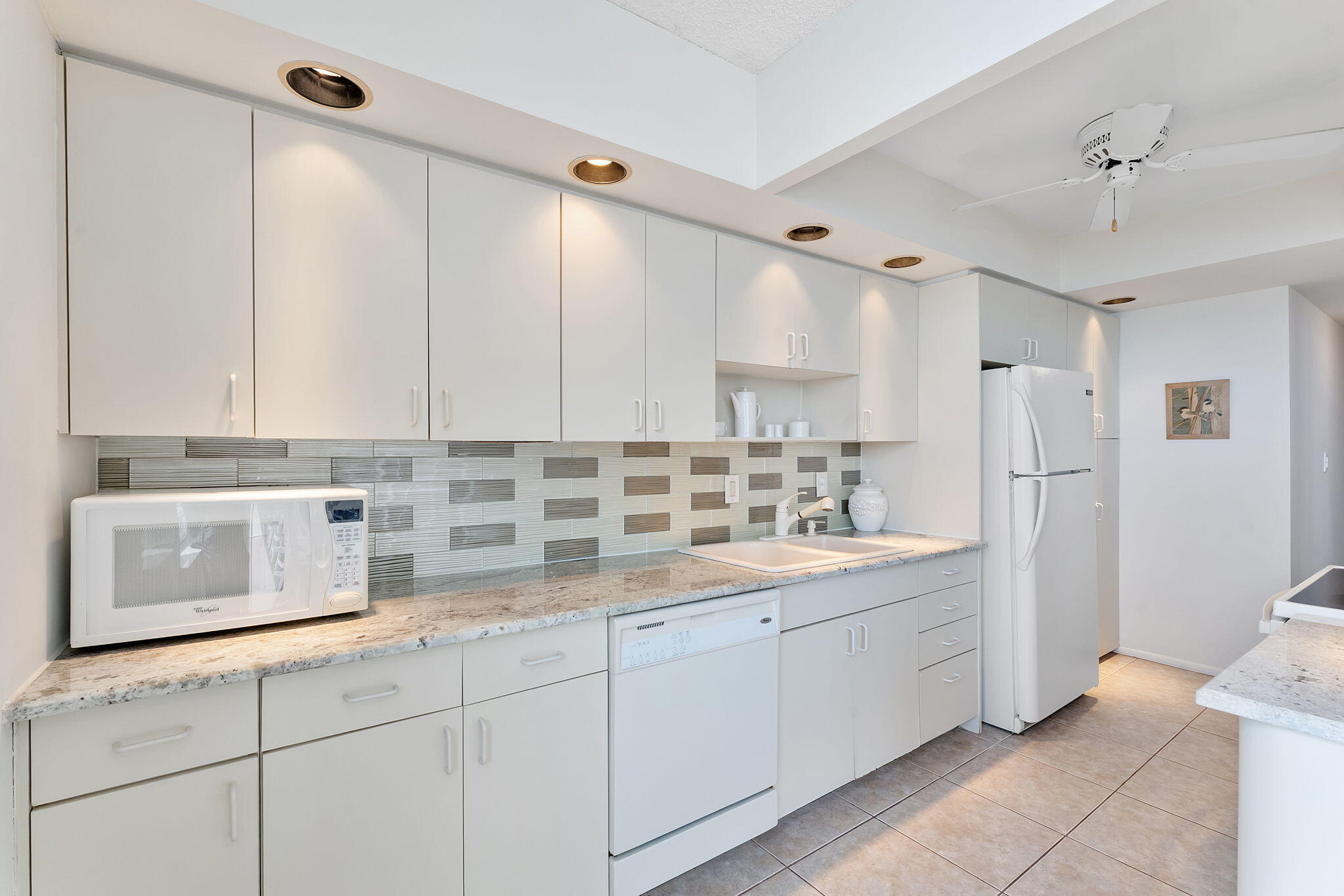 2000 South Ocean Boulevard, Unit 10H Boca Raton, FL 33432 - Photo 11 of 54 a kitchen with a sink and cabinets