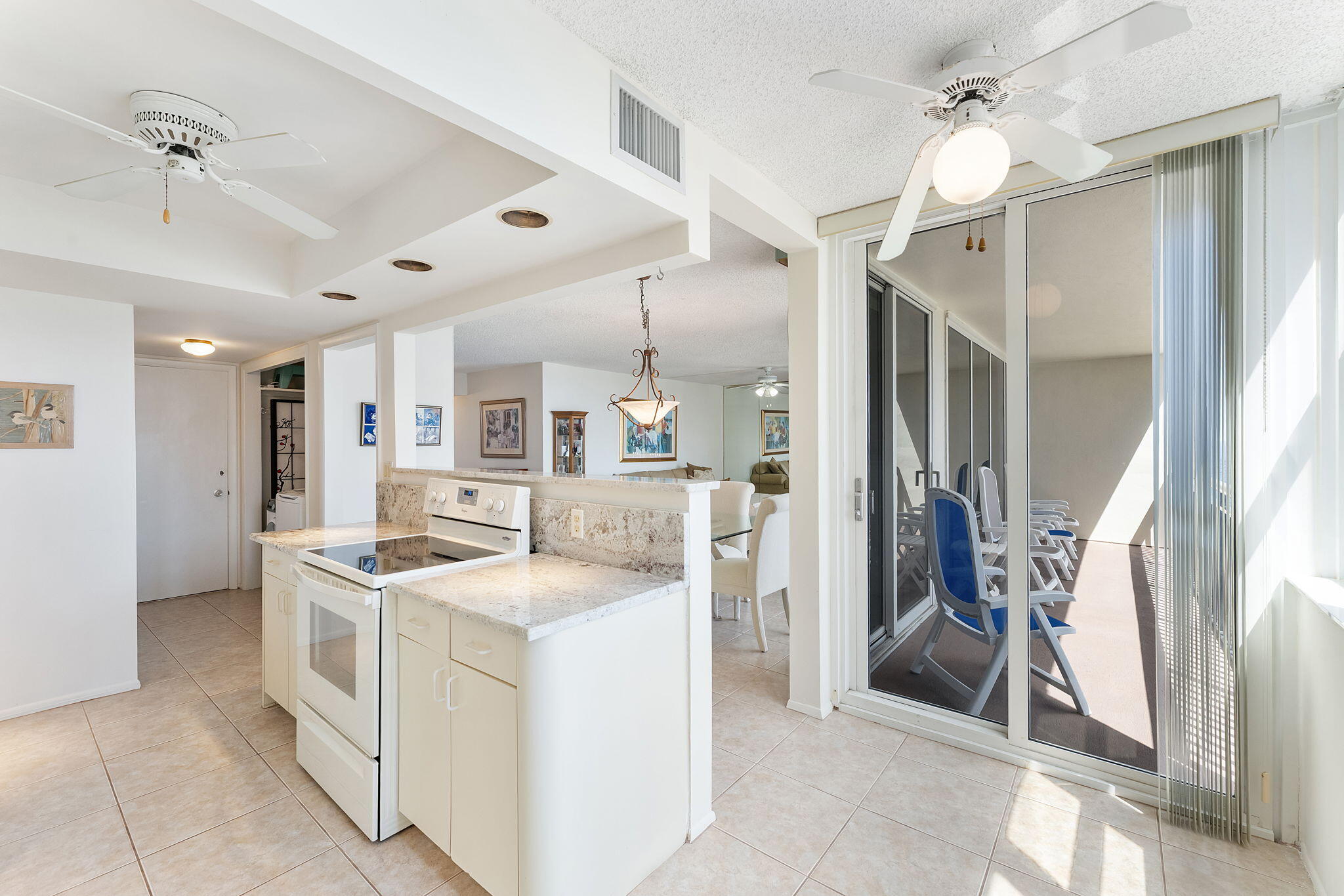 2000 South Ocean Boulevard, Unit 10H Boca Raton, FL 33432 - Photo 12 of 54 a kitchen that has a lot of white cabinets and stainless steel appliances