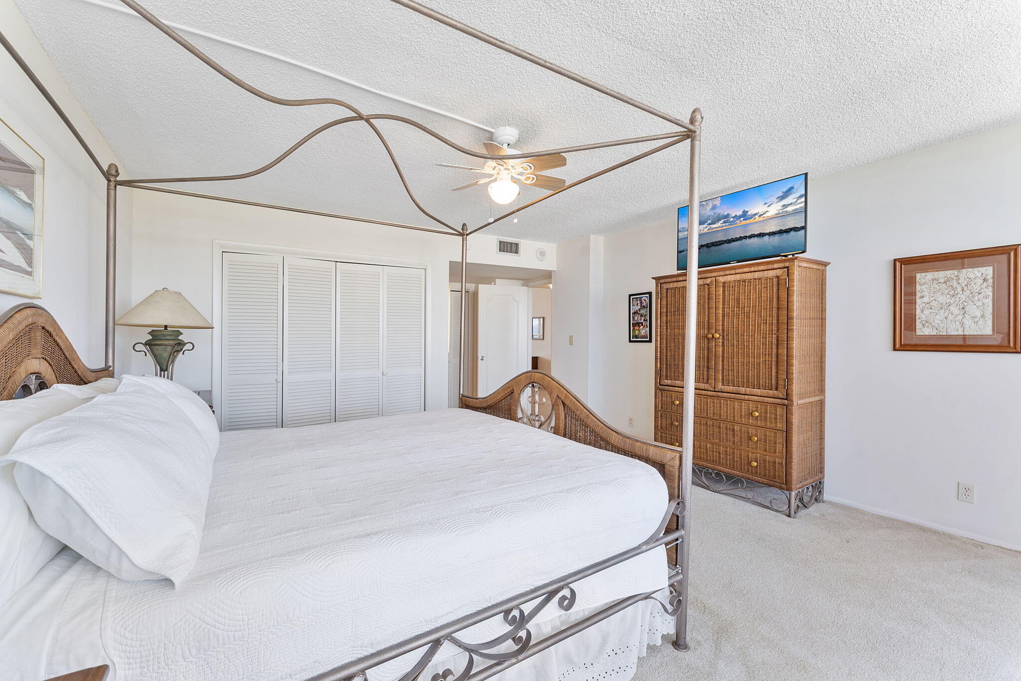 2000 South Ocean Boulevard, Unit 10H Boca Raton, FL 33432 - Photo 19 of 54 a bed room with a bed and a chandelier