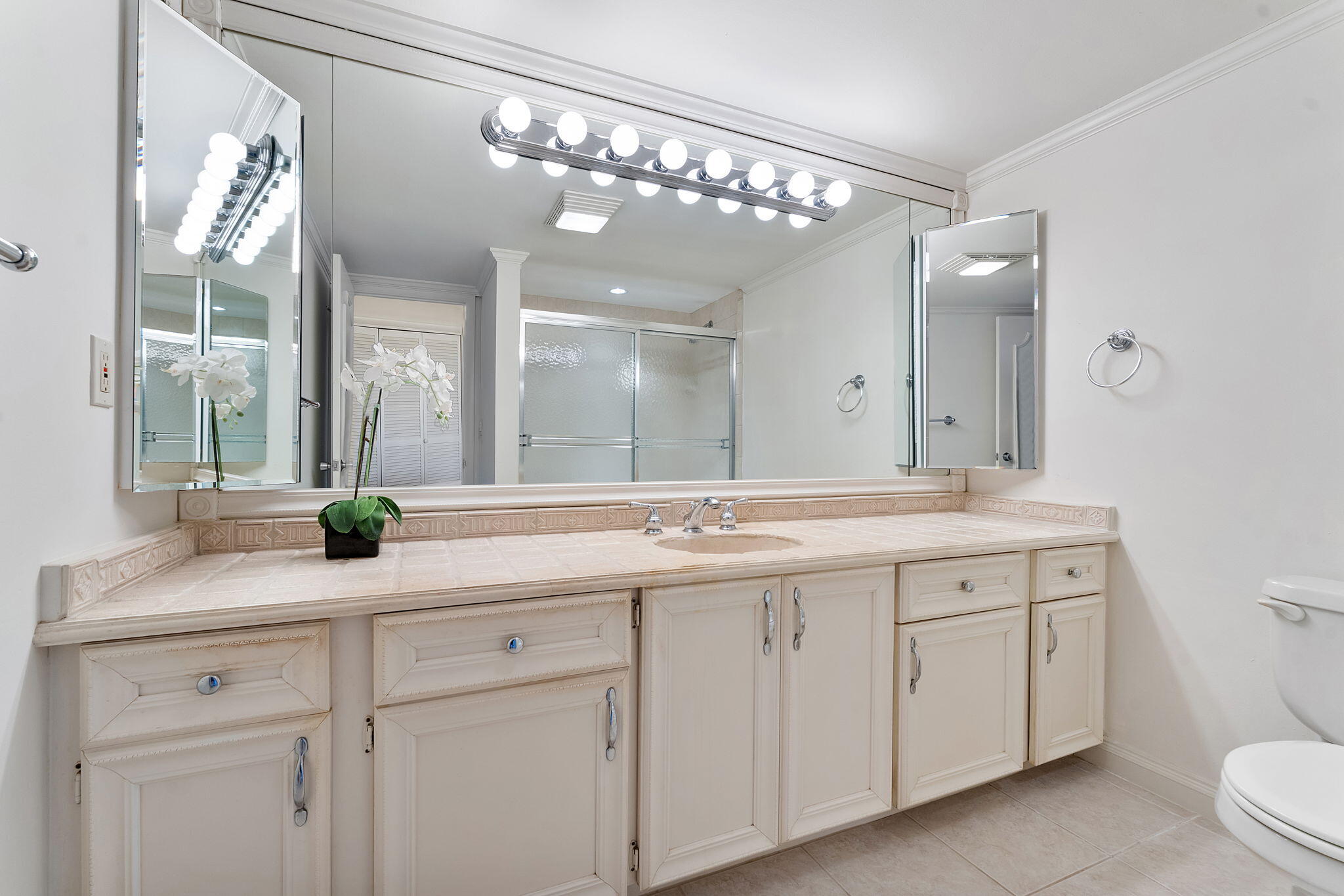 2000 South Ocean Boulevard, Unit 10H Boca Raton, FL 33432 - Photo 21 of 54 a bathroom with a sink a toilet and a mirror