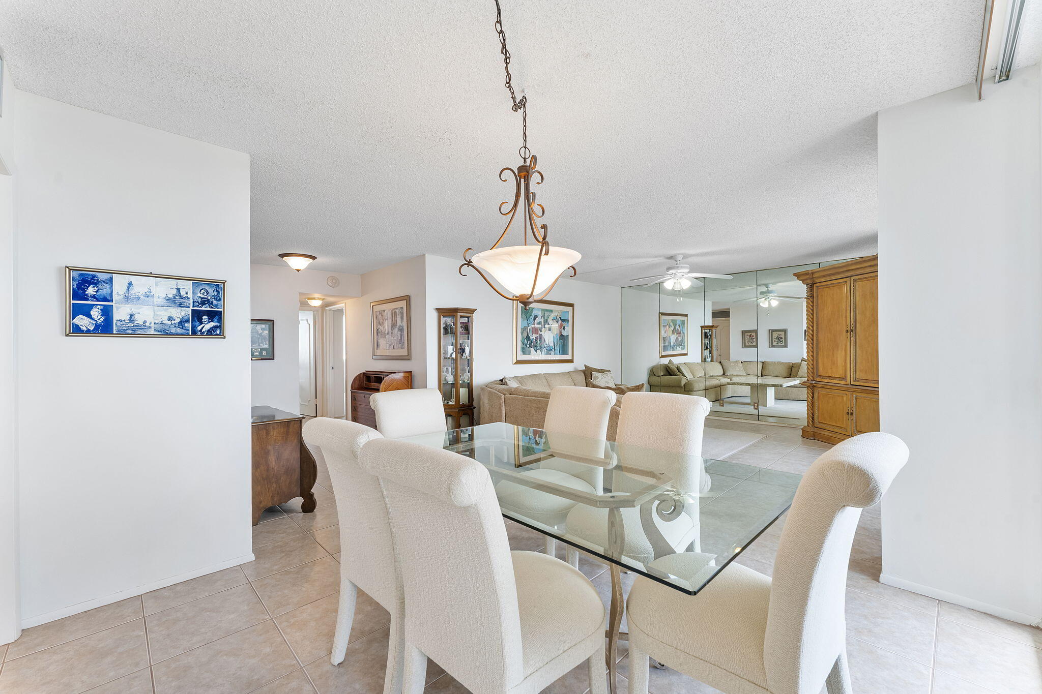 2000 South Ocean Boulevard, Unit 10H Boca Raton, FL 33432 - Photo 10 of 54 a view of a dining room and livingroom with furniture wooden floor a chandelier