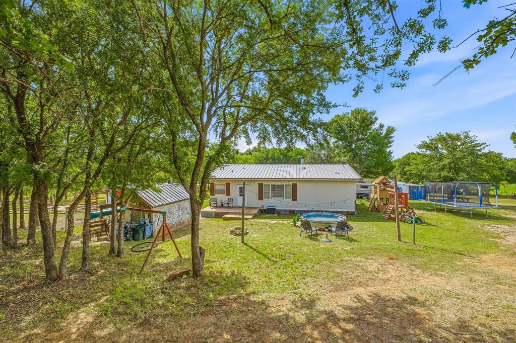 151 High Point Road Weatherford, TX 76088 - Photo 21 of 40 a view of a house with a backyard porch and sitting area