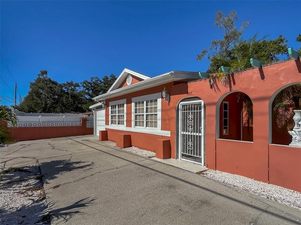 3957 Proctor Road Sarasota, FL 34233 - Photo 2 of 18 a front view of a house with a yard