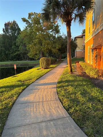 a view of a porch with wooden floor and outdoor seating