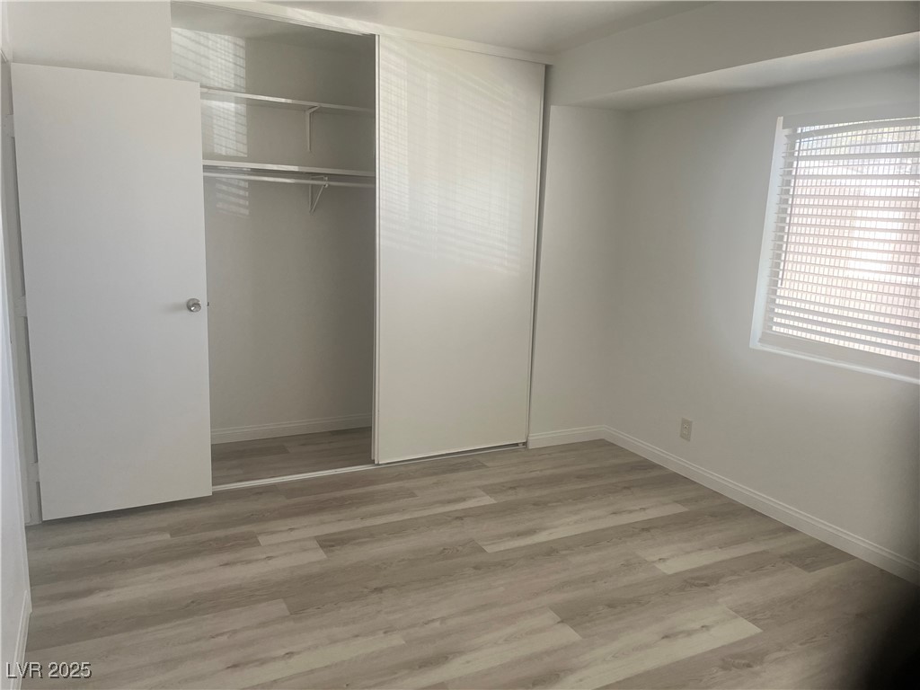 592 Sea Shell Lane Las Vegas, NV 89110 - Photo 19 of 24 Unfurnished bedroom featuring light wood-style flooring and a closet