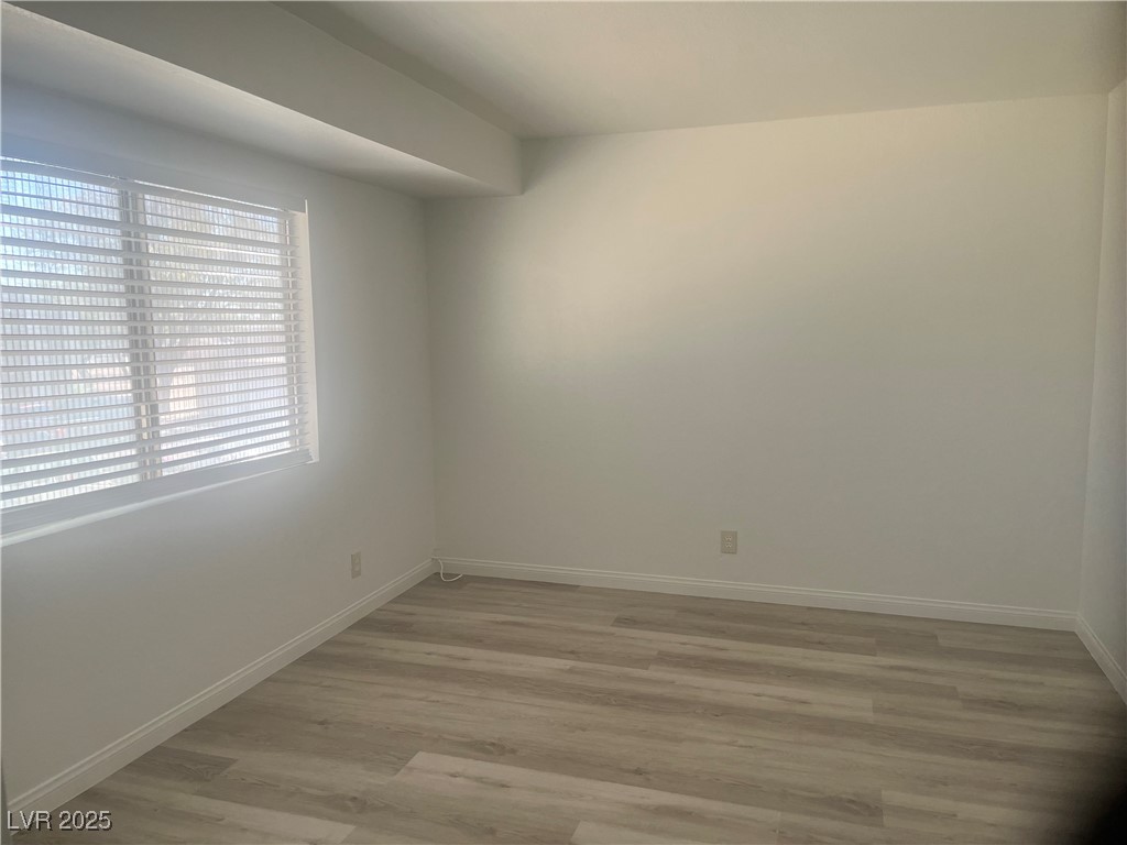 592 Sea Shell Lane Las Vegas, NV 89110 - Photo 21 of 24 Spare room featuring light wood-type flooring and baseboards