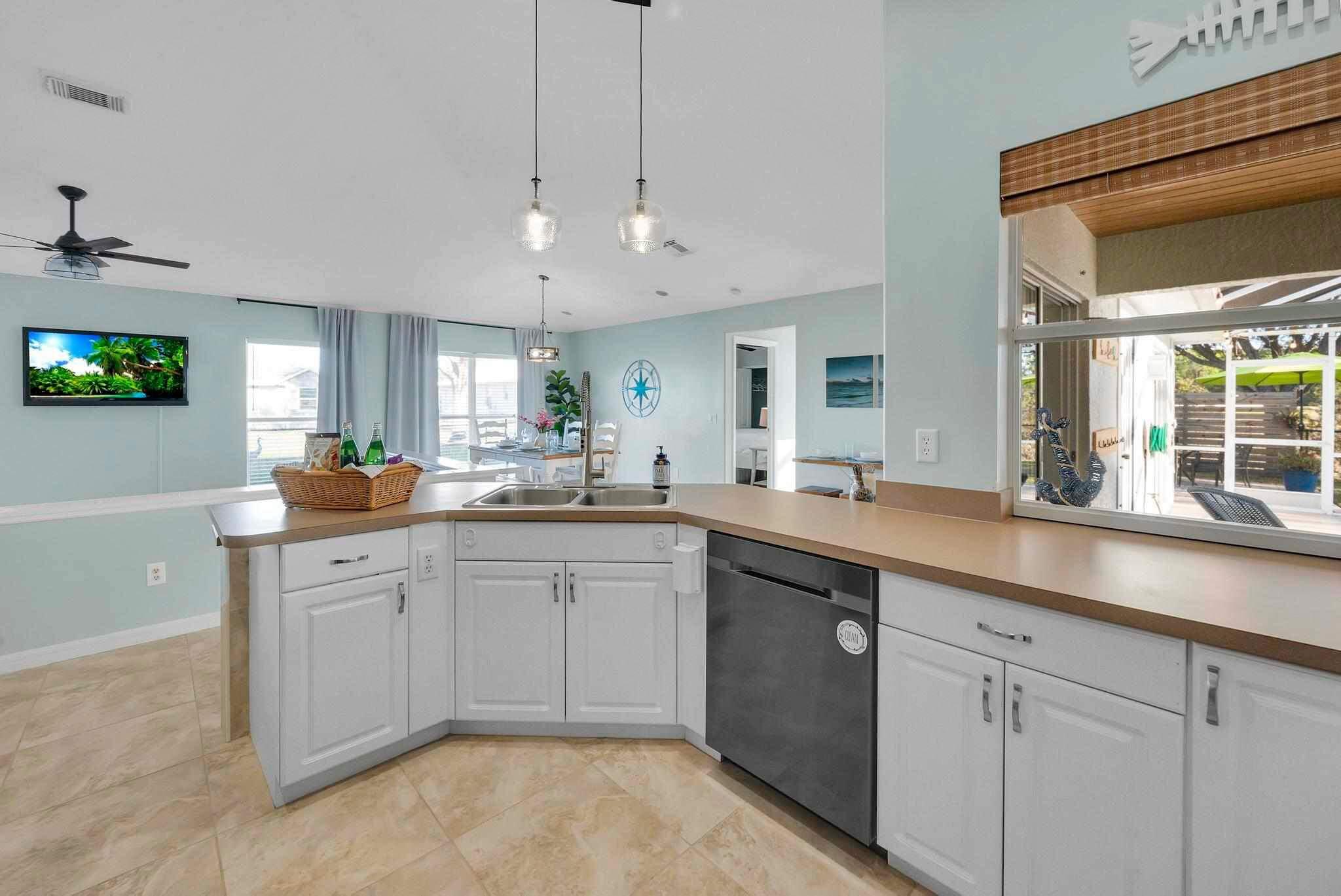 5464 Northwest Milner Drive Port St. Lucie, FL 34983 - Photo 14 of 49 a kitchen with a sink cabinets and window