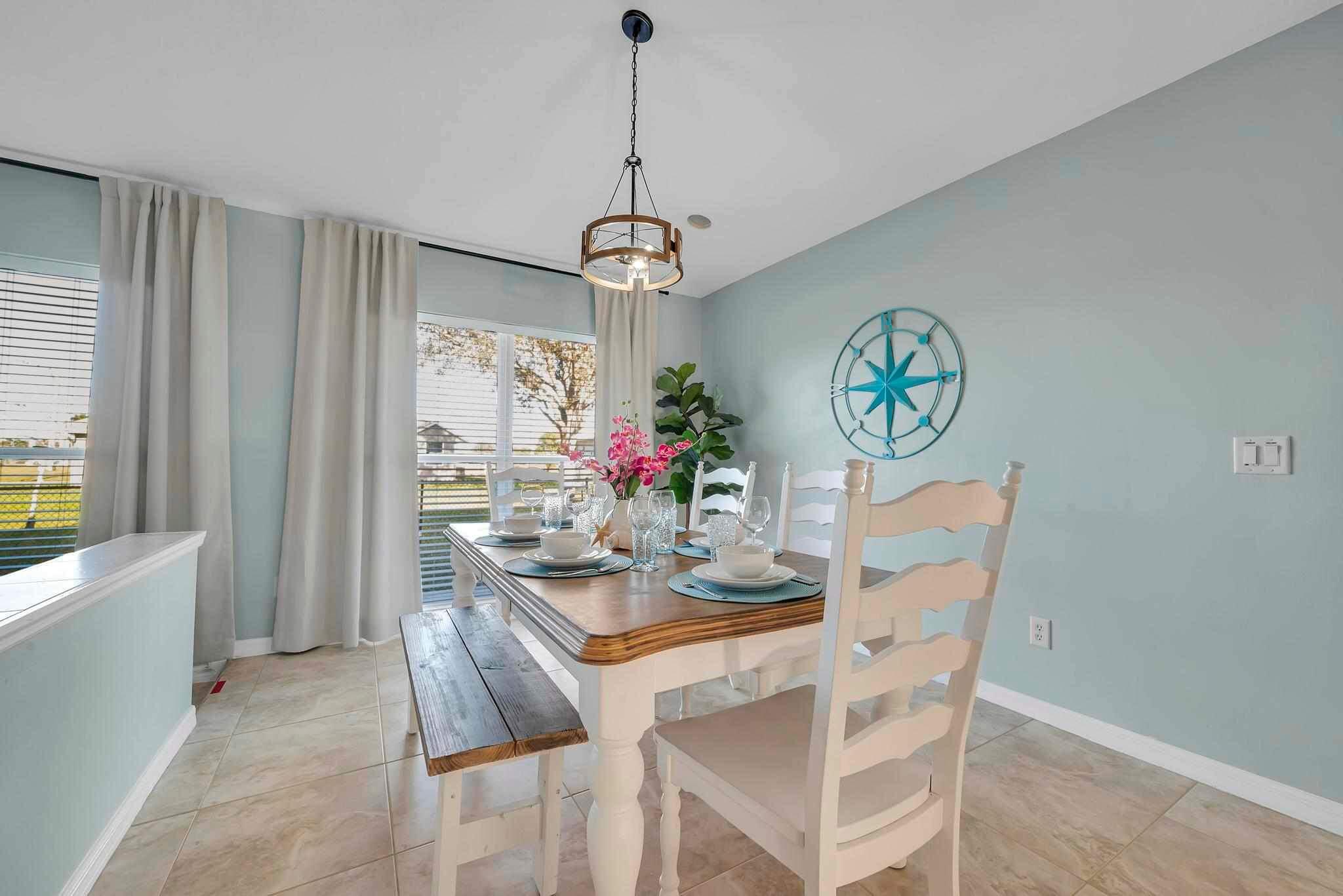 5464 Northwest Milner Drive Port St. Lucie, FL 34983 - Photo 18 of 49 a view of a dining room with furniture window and wooden floor