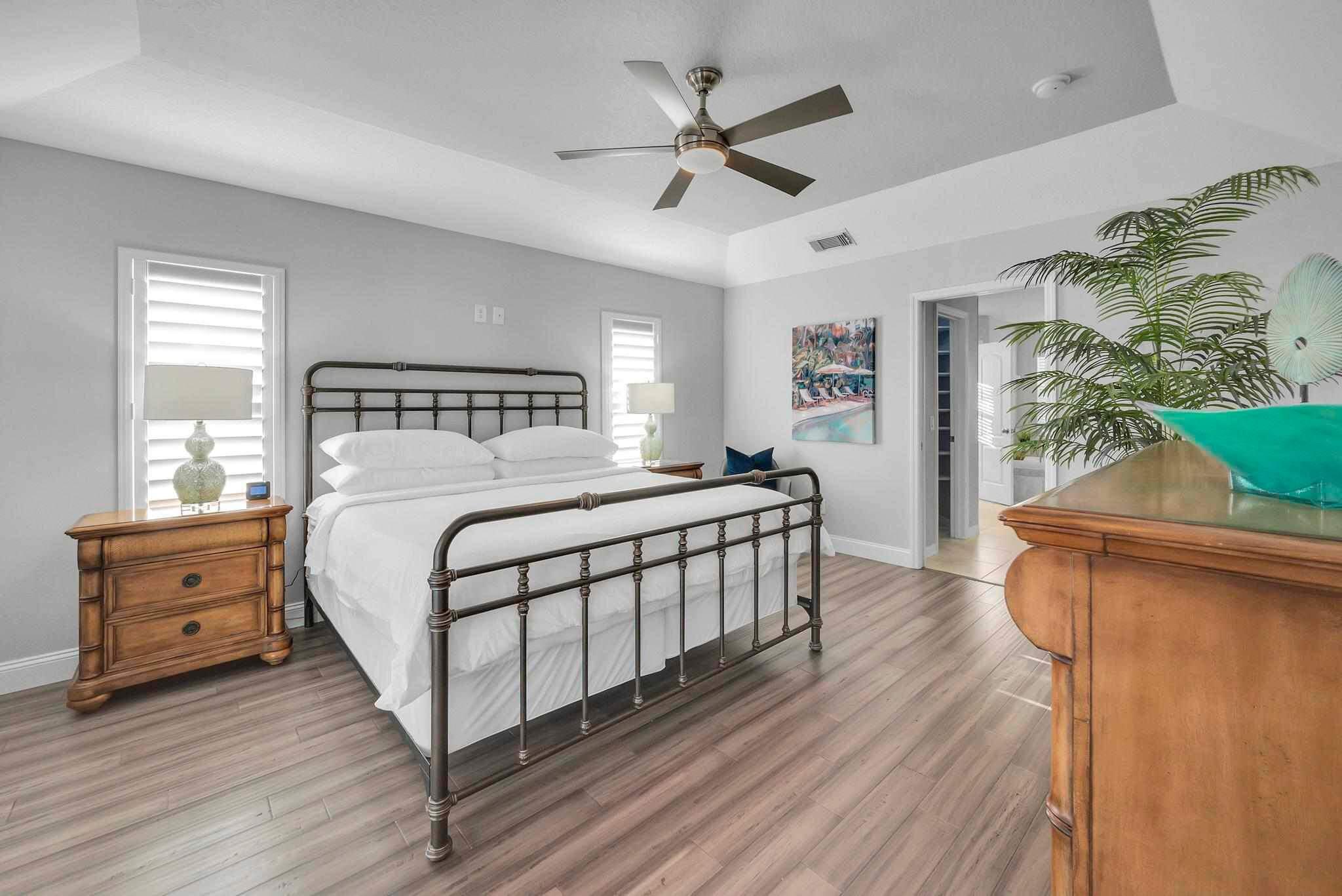 5464 Northwest Milner Drive Port St. Lucie, FL 34983 - Photo 22 of 49 a bedroom with a bed and a dresser