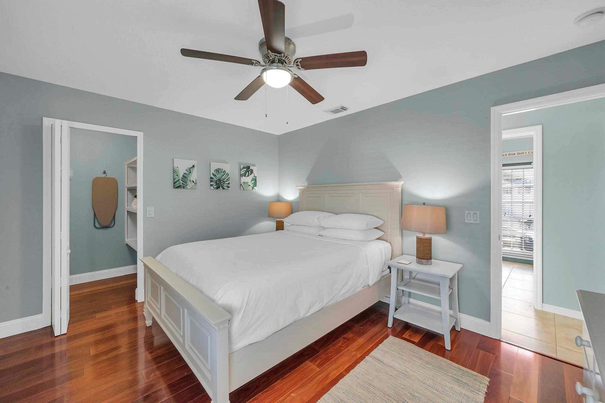 5464 Northwest Milner Drive Port St. Lucie, FL 34983 - Photo 30 of 49 a bedroom with a bed and wooden floor