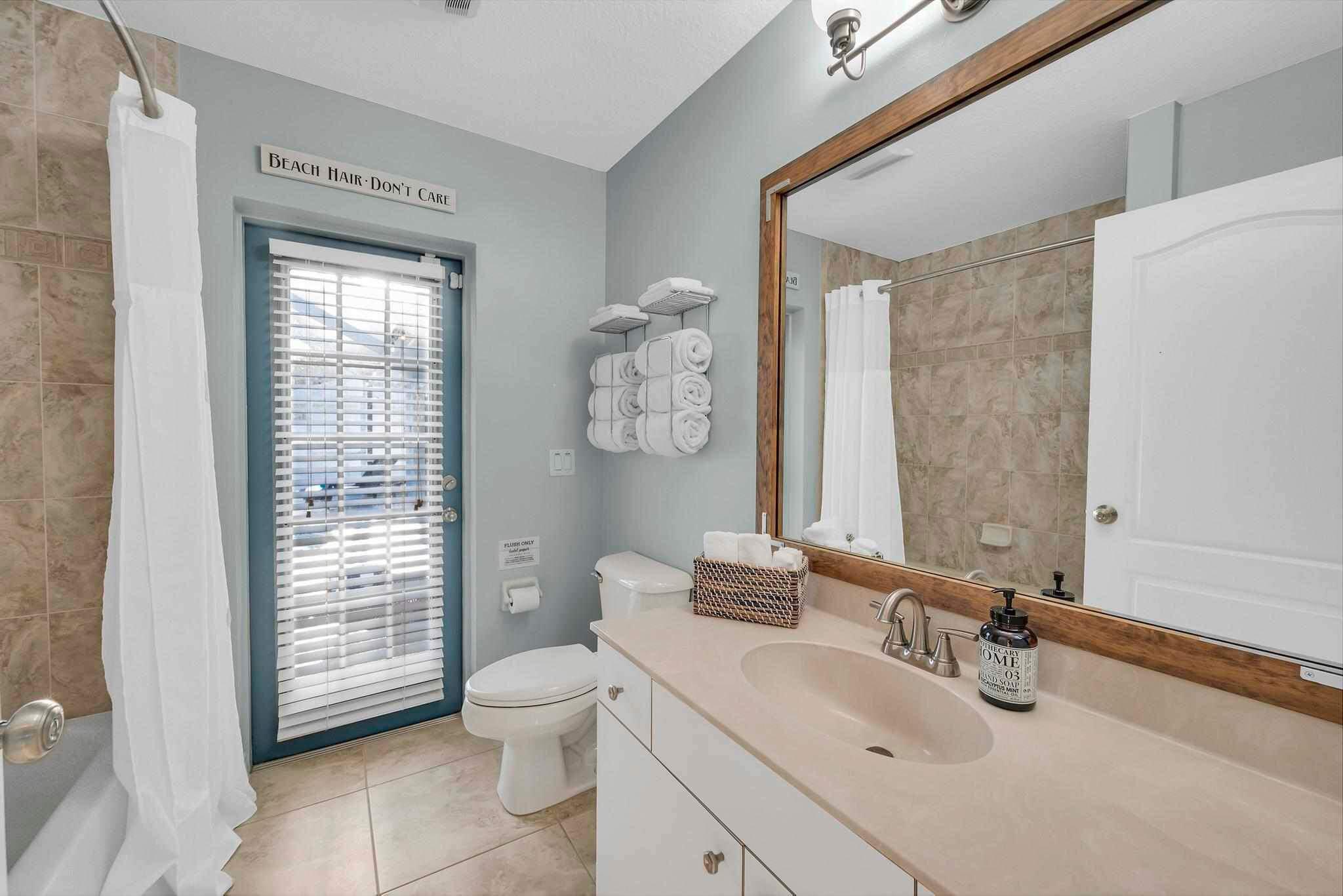 5464 Northwest Milner Drive Port St. Lucie, FL 34983 - Photo 37 of 49 a bathroom with a toilet a sink and mirror