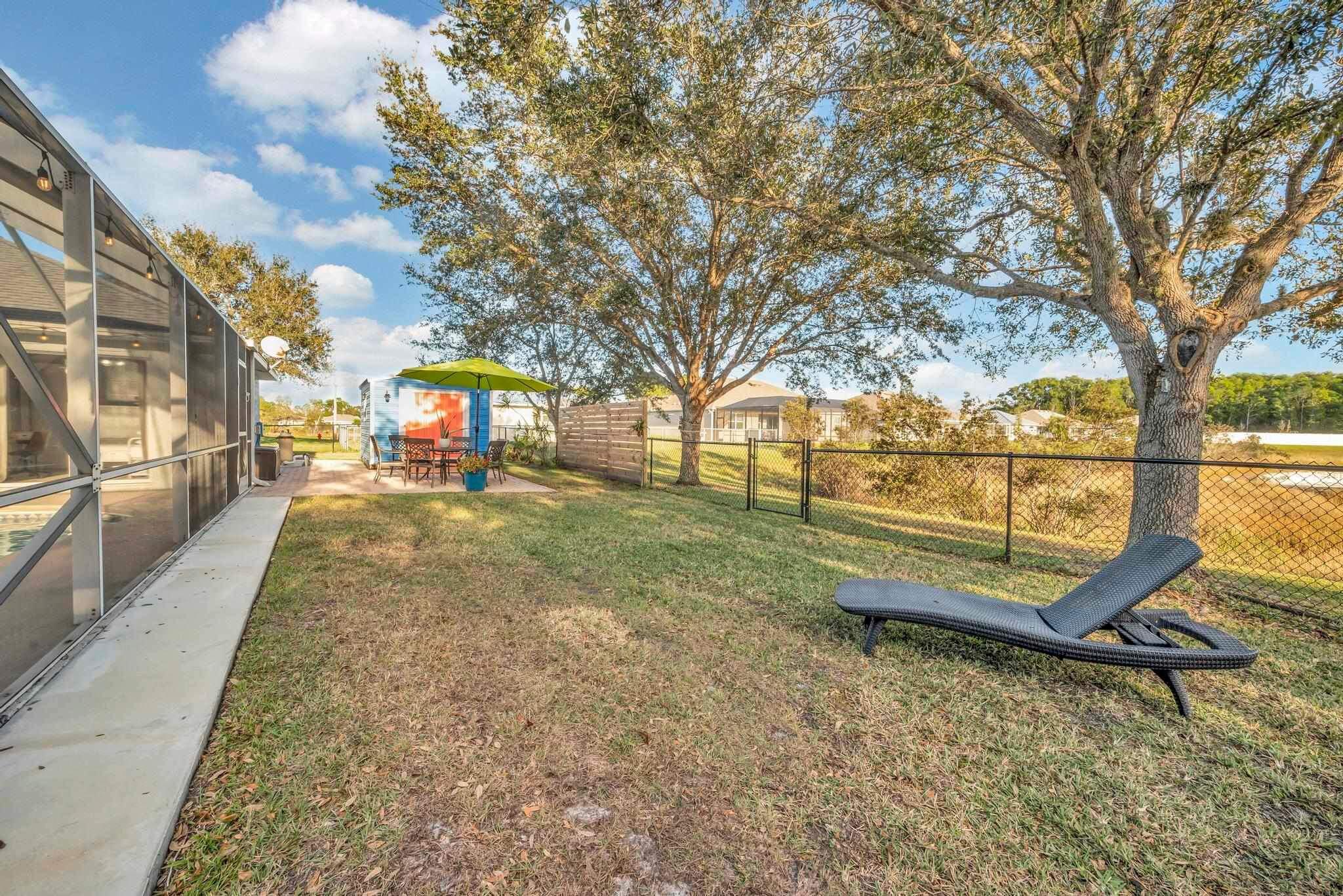 5464 Northwest Milner Drive Port St. Lucie, FL 34983 - Photo 46 of 49 a view of a yard with wooden fence