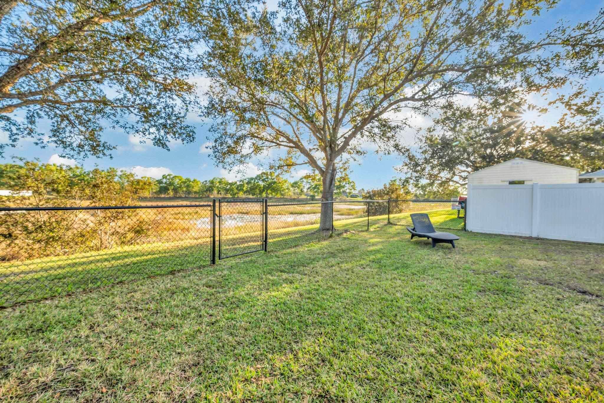 5464 Northwest Milner Drive Port St. Lucie, FL 34983 - Photo 48 of 49 a garden with wooden fence
