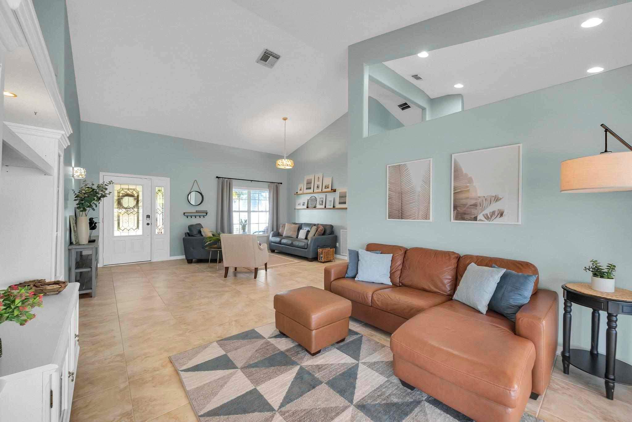 5464 Northwest Milner Drive Port St. Lucie, FL 34983 - Photo 9 of 49 a living room with furniture and wooden floor