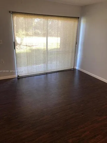 a view of wooden floor and windows in a room