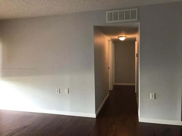 an empty room with an empty space and wooden floor