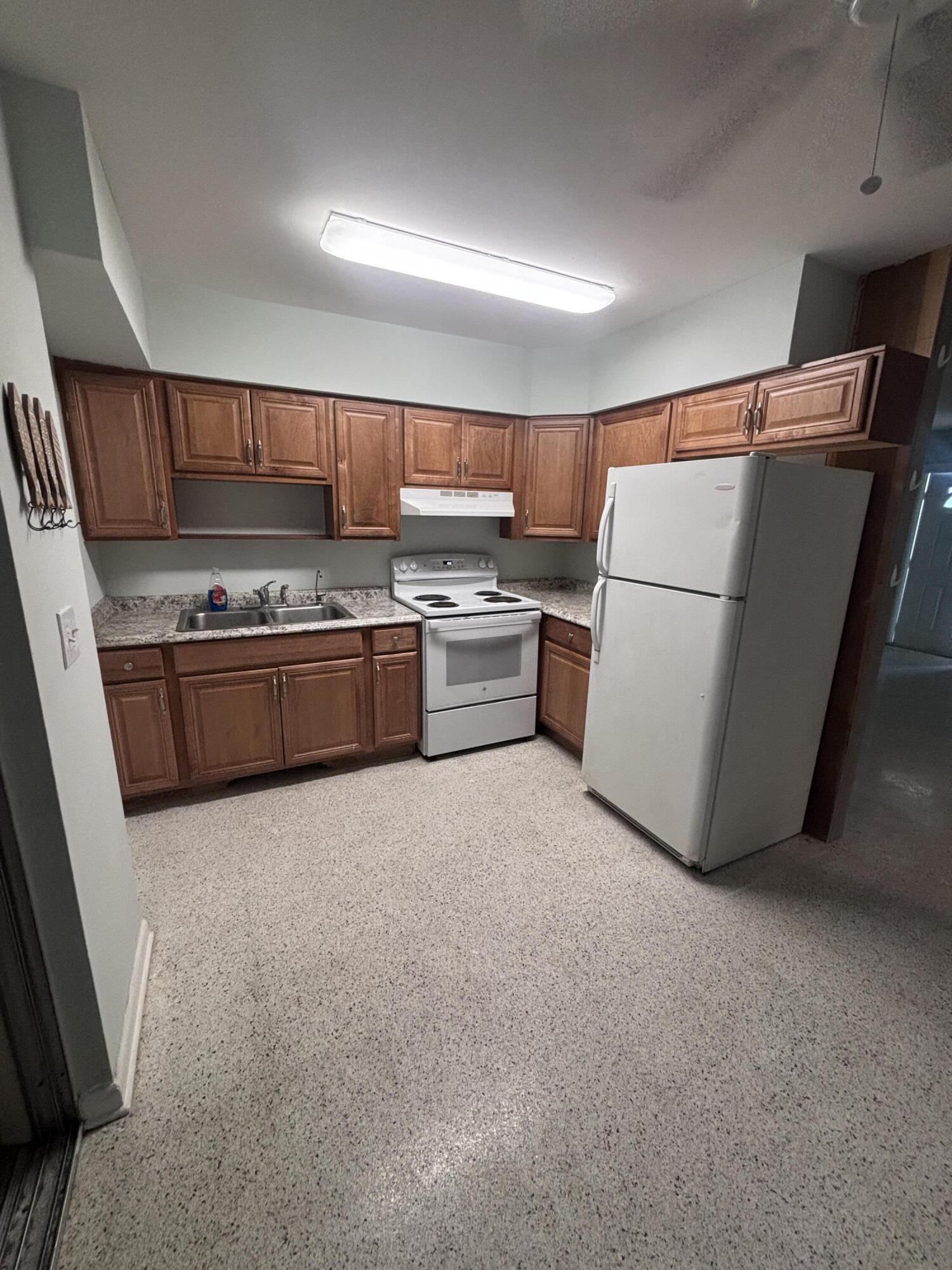 202 Balboa Street, Unit A Fort Pierce, FL 34949 - Photo 2 of 10 a kitchen with sink refrigerator and stove