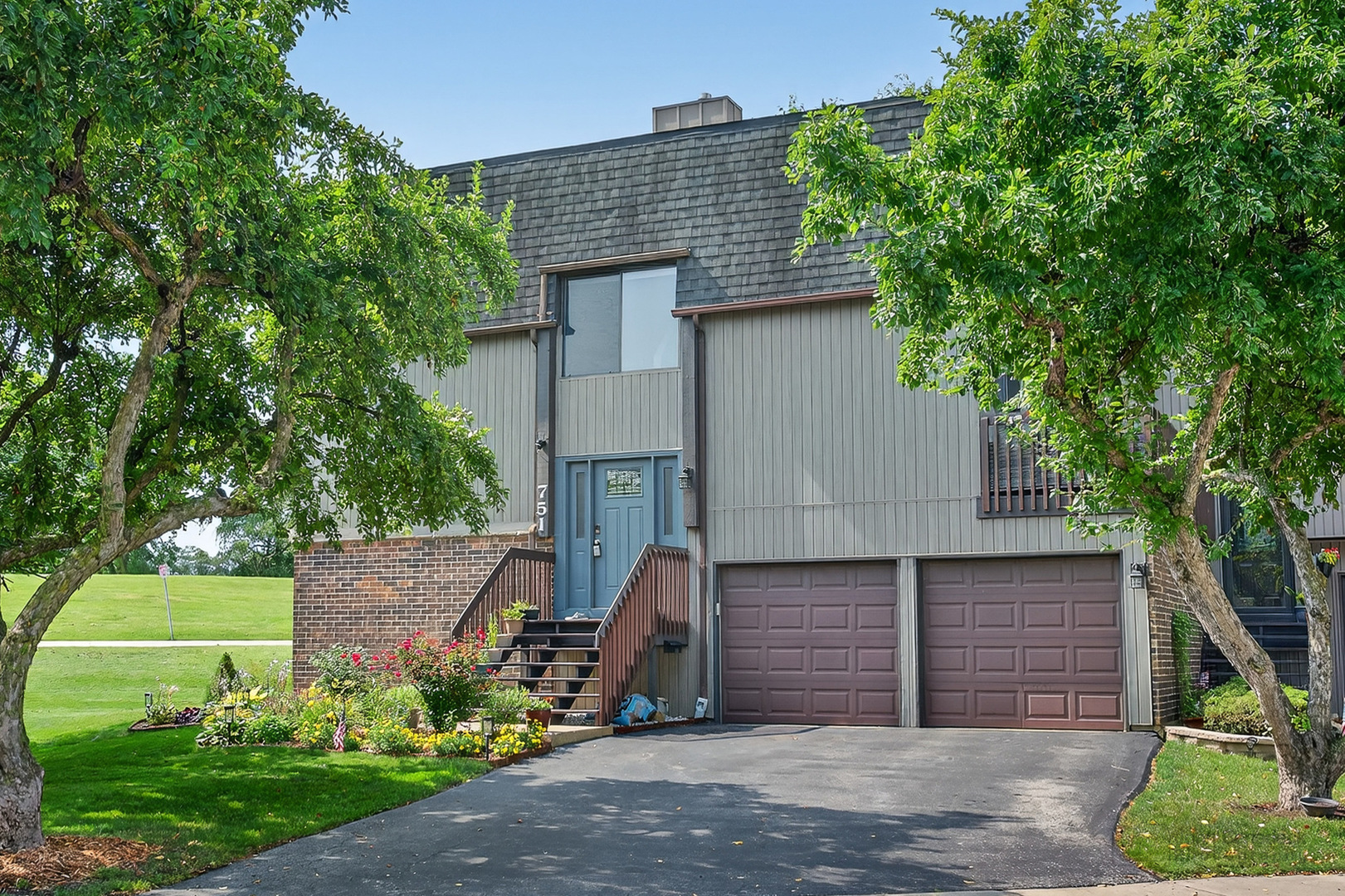 a front view of a house with garden