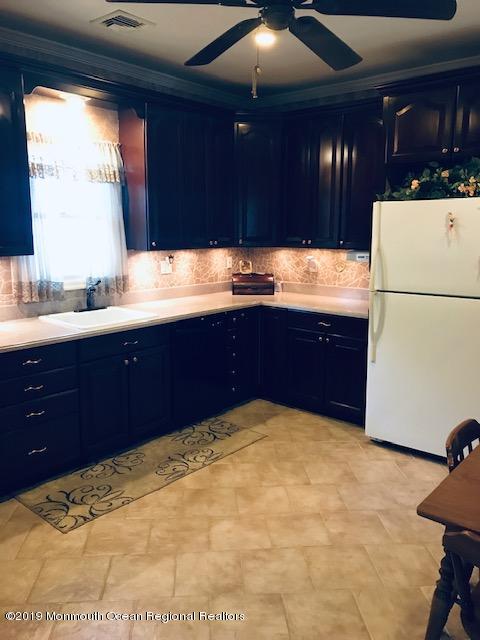 176 Stony Road Edison, NJ 08817 - Photo 7 of 29 a kitchen with sink and cabinets