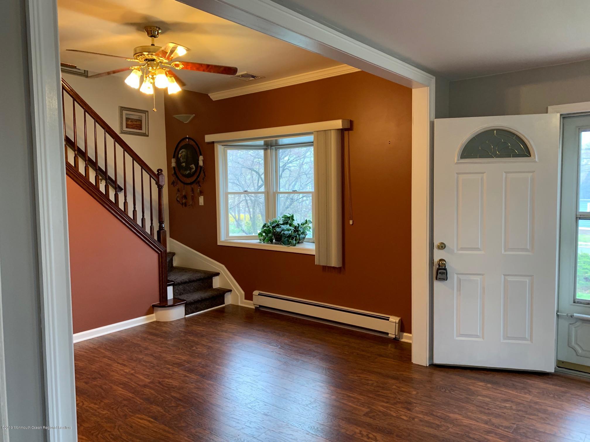176 Stony Road Edison, NJ 08817 - Photo 9 of 29 a view of an entryway with wooden floor and a ceiling fan