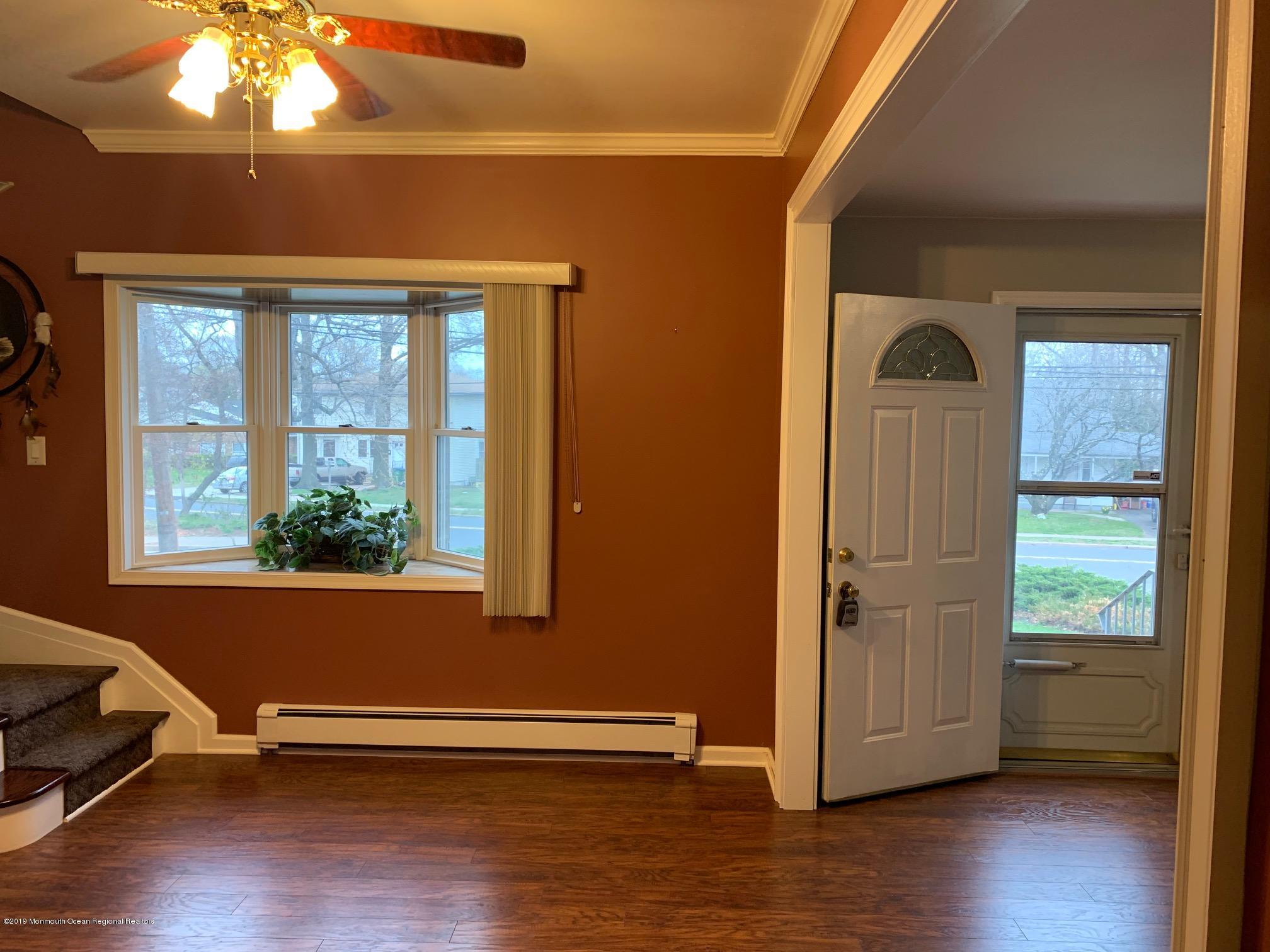 176 Stony Road Edison, NJ 08817 - Photo 10 of 29 a view of empty room with wooden floor and fan