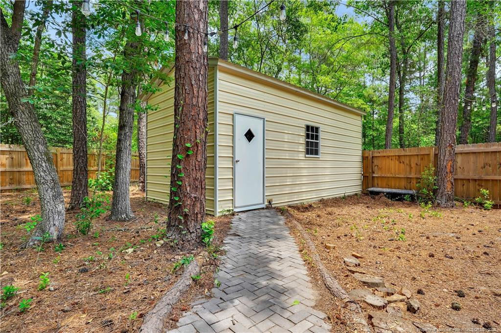 8155 Arabia Road Lumber Bridge, NC 28357 - Photo 27 of 30 a view of a house with backyard and trees