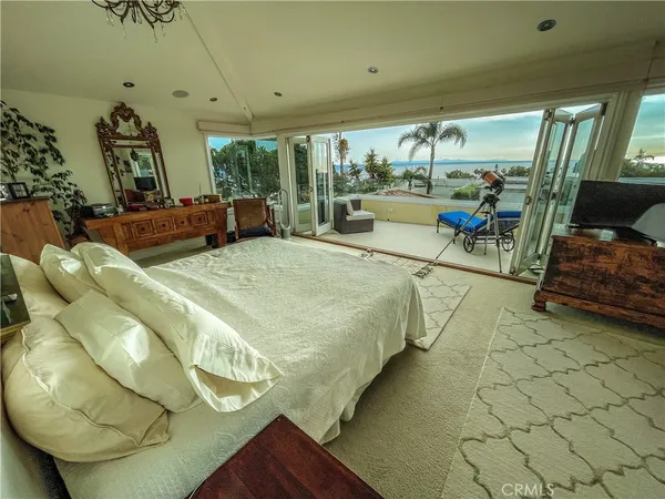 a bed room with a bed and a chair