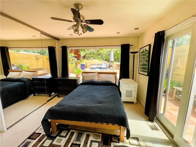 a bedroom with a bed window and a flat screen tv