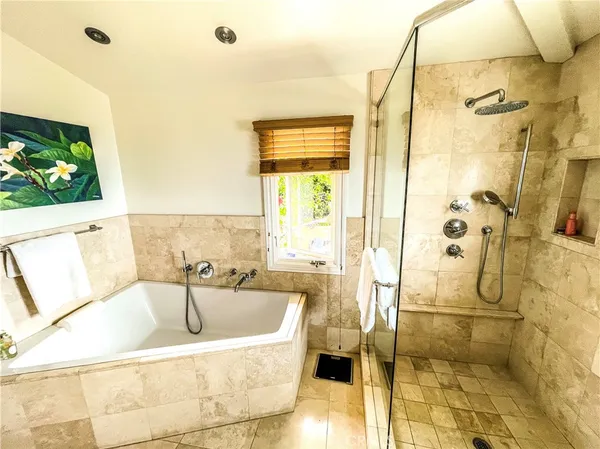 a bathroom with a tub sink and mirror