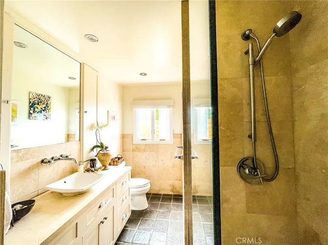 a bathroom with a tub a sink and a shower