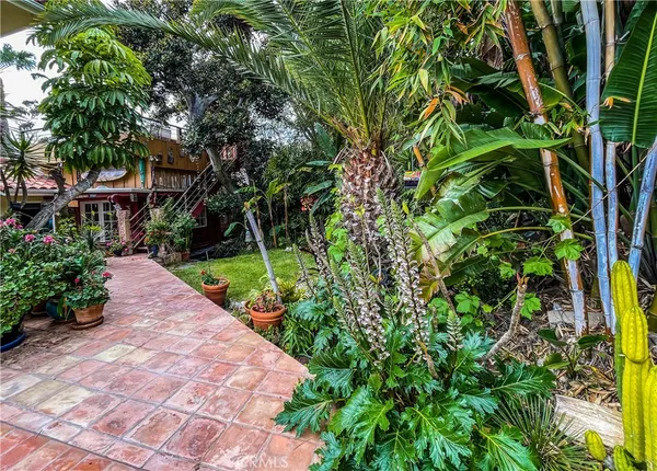 a view of a house with a yard and sitting area